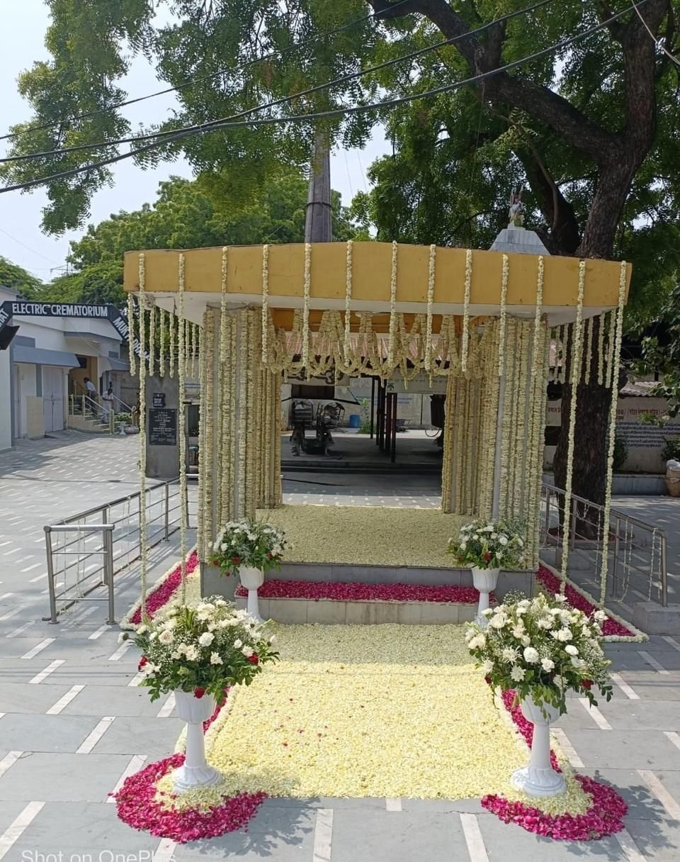 Lodhi Road electric crematorium pavilion decorated with cream marigold garlands and floral arrangements by Last Ride Funeral