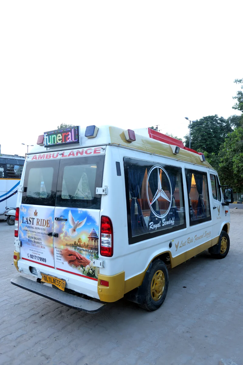 Rear portrait view of Last Ride Funeral premium hearse van showing LED FUNERAL marquee strip, Mercedes star emblem on glass panel and Royal Sendoff custom fit-out — Delhi